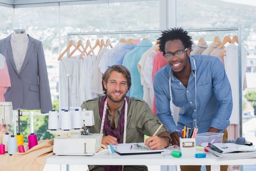 Attractive fashion designers working together in a bright office