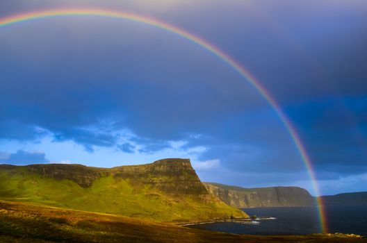 Rainbow over a dramatic coast of Scottish highlands, Isle of Skye, United Kingdom