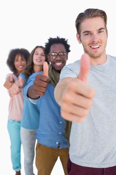 Cheerful people in row with thumbs up against white background