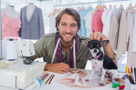 Fashion designer petting his cute chihuahua