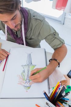 Fashion designer drawing a coat with pencils