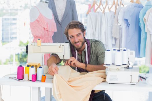 Fashion designer in a creative office using sewing machine