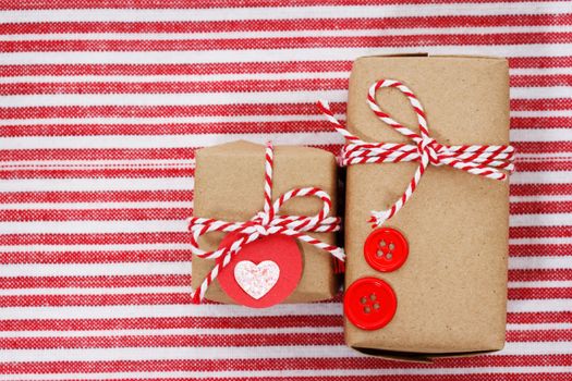 Handmade craft gift boxes on striped cloth