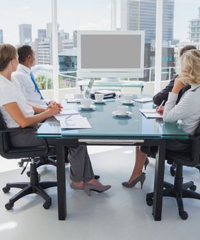 Business people gathered for a video conference in the boardroom