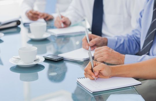 Business people hands taking some notes during a meeting