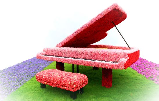 Piano with flower decoration on grass