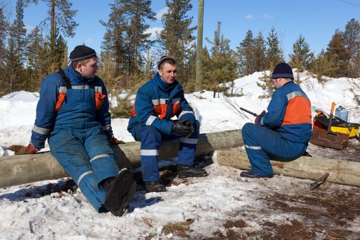 Three electric, sit on logs.  Work breaks. Good mood. The end of winter