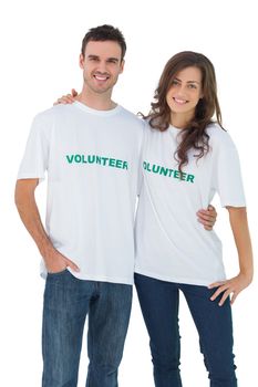 Two cheerful people wearing volunteer tshirt on white background