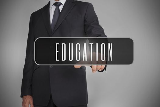 Businessman selecting label with education written on it on grey background