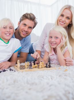 Family playing chess in the living room