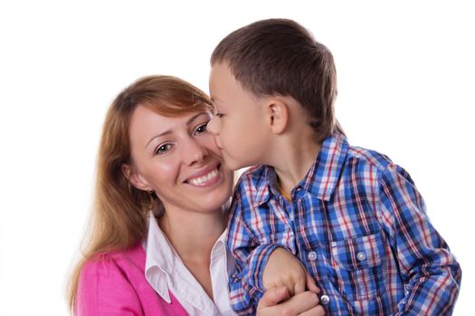 Happy mother and son kissing on cheek over white