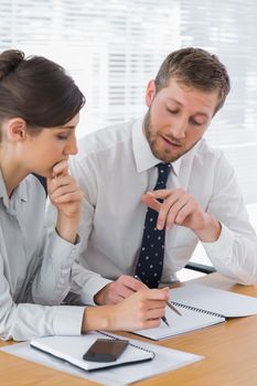 Business people planning together at desk in office