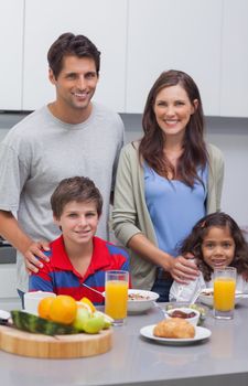 Smiling family at breakfast in kitchen