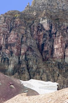 This is the side of Mount Reynolds at Glacier National Park. It colors many shades of purple rock and a small snow field at the base.