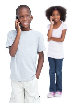 Brother and sister on the phone on a white background