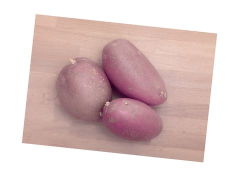 A close up shot of potatoes on a chopping board