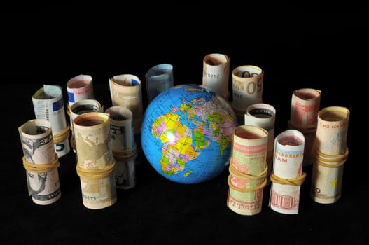 The Planet Earth and Rolled Money Financial Concept
