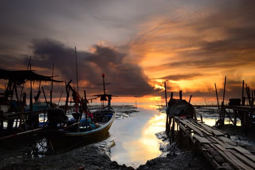 fishing boat with sunrise background at thailand