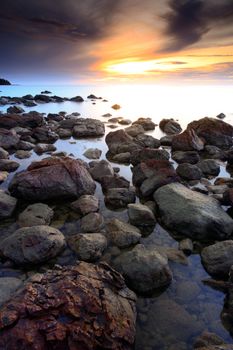 beautiful seascape of wave and rock and the sunset