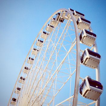 Ferris wheel with clear blue sky, retro filter effect
