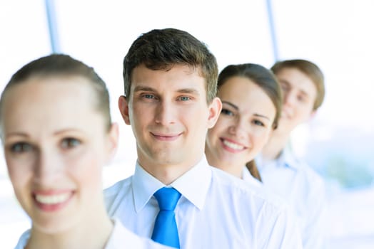 portrait of a young businessman standing in a row with his colleagues, concept of teamwork
