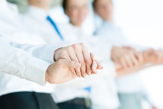 hands of businessmen, businessmen hold hands, stand in a row, the concept of teamwork