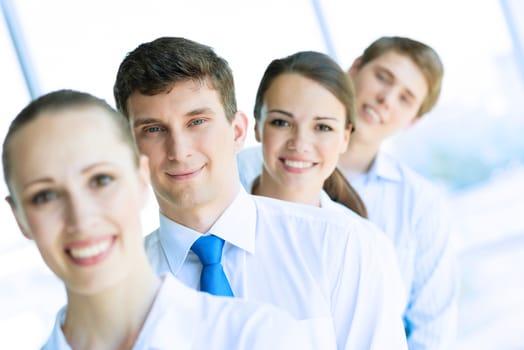 portrait of a young businessman standing in a row with his colleagues, concept of teamwork