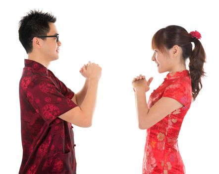 Side view Asian man and woman with Chinese traditional dress cheongsam. Chinese new year concept, isolated on white background.