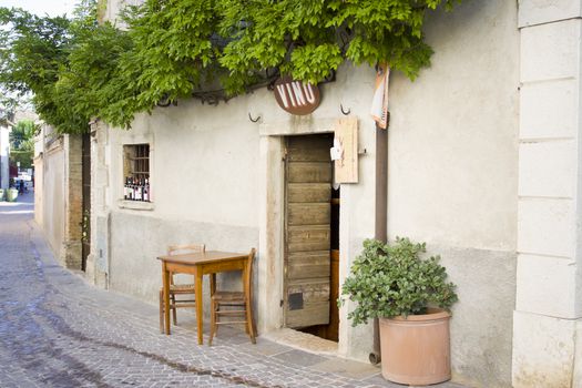 A bar with table and chairs outside in Castellaro Lagusello, Monzambano, Garda lake area, Italy, Europe