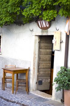 A bar with table and chairs outside in Castellaro Lagusello, Monzambano, Garda lake area, Italy, Europe