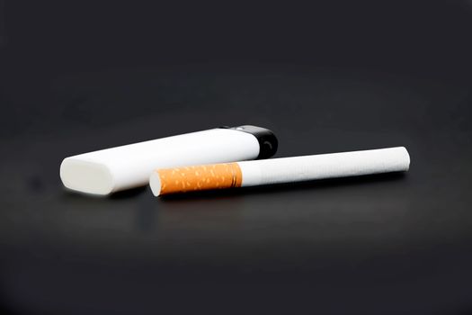 white lighter and one cigarette on gray background