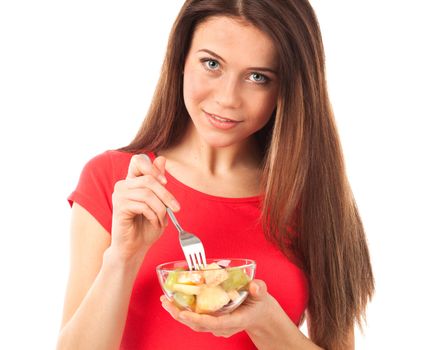 Young woman eating fruits with a fork, isolated on white