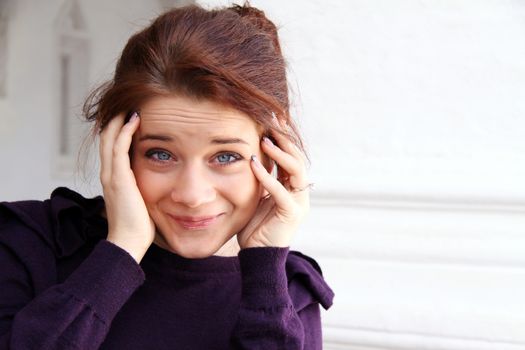 young girl wrinkles a forehead