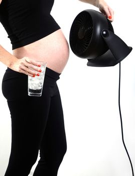 hot pregnant woman trying to cool down from hot flash during pregnancy