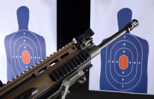 machine gun or assault rifle and bullseye targets at gun range