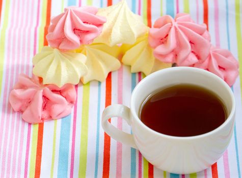 Pink colored meringue and a teacup