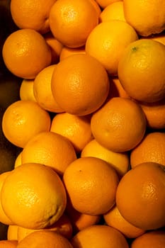 Heap of orange fruits (close up) against dark background