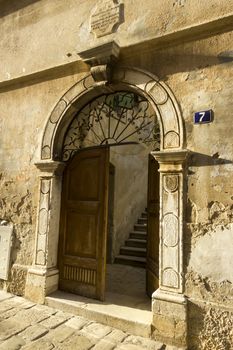 Ancient door on the street in Porec, Croatia