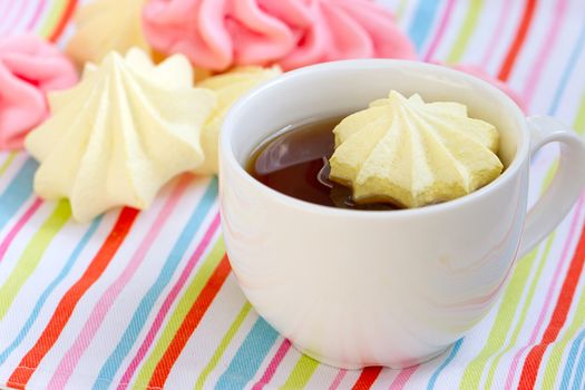 Pink colored meringue and a teacup