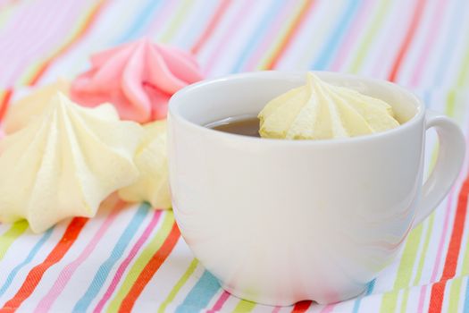 Pink colored meringue and a teacup