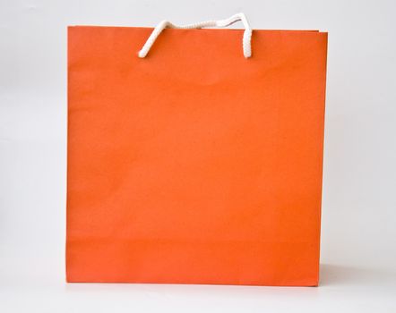 orange paper bag on white background