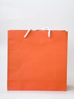 orange paper bag on white background