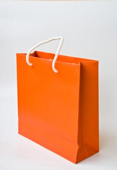 orange paper bag on white background