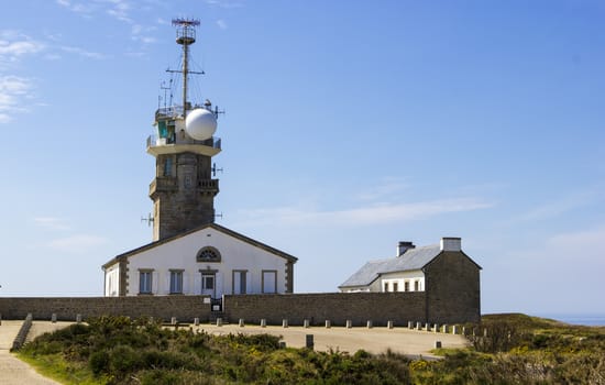 Old stone lighthouse with modern equipment, Cape Ra, (Pointe du Raz), westernmost France point