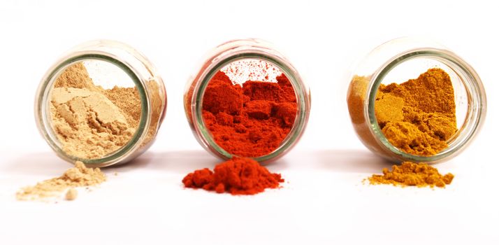 Variety of spices in a glass pot, focus in the back.

