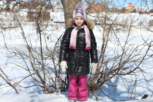Beautiful little girl in winter park