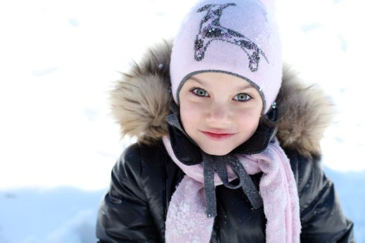 Beautiful little girl in winter park