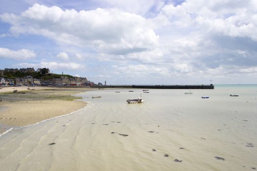 Nicel boats on the calm blue sea at low tide time, northern France