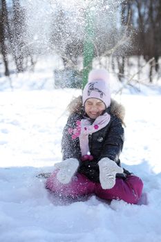 Beautiful little girl in winter park