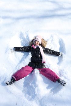 Beautiful little girl in winter park